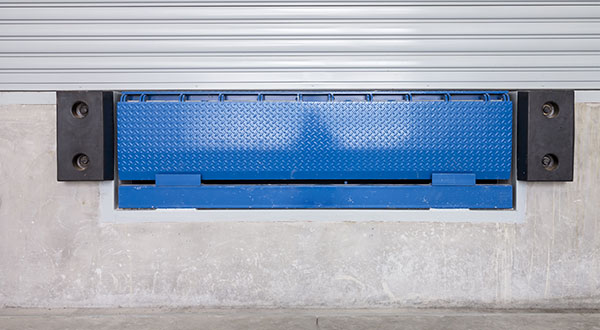 Edge-of-dock leveler at commercial facility
