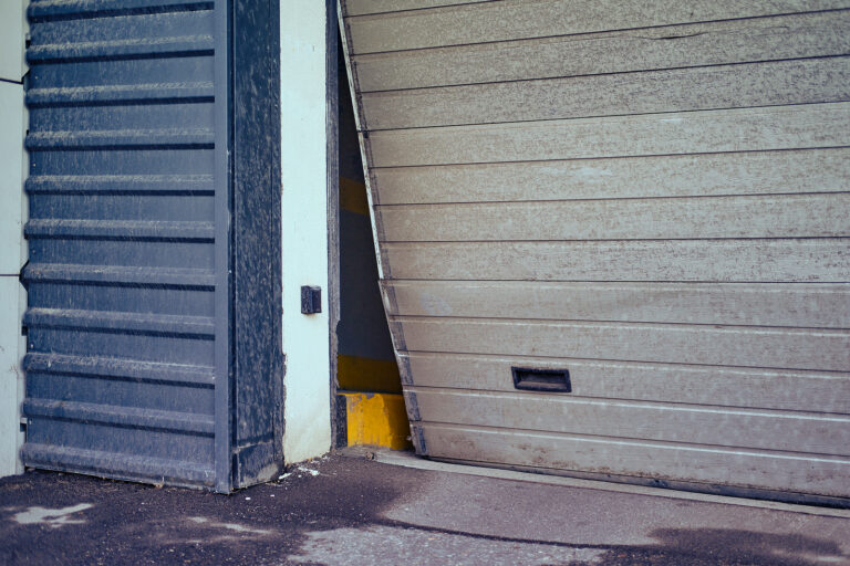 The rolling steel door is partially torn